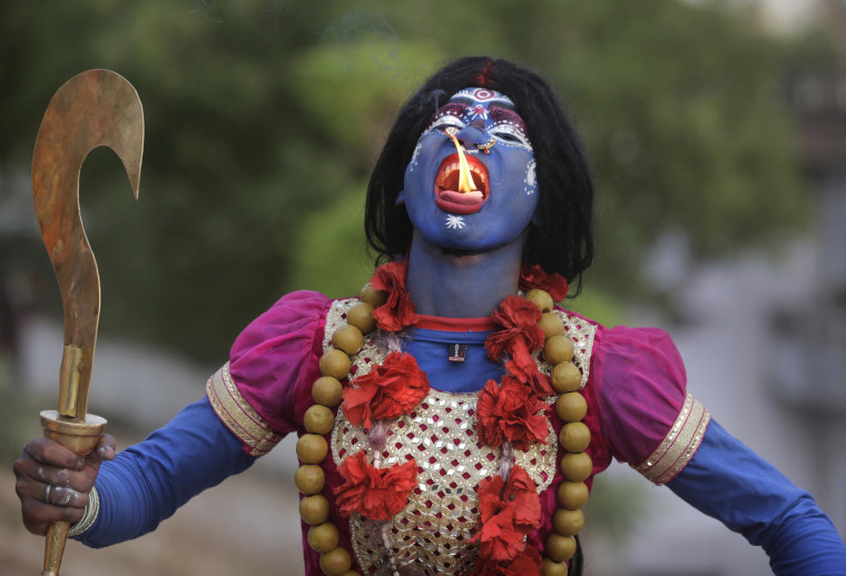 Image: An Indian man dressed as Hindu Goddess Kali