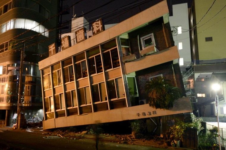 Image: A severely damaged dentist office leans to one side following an earthquake