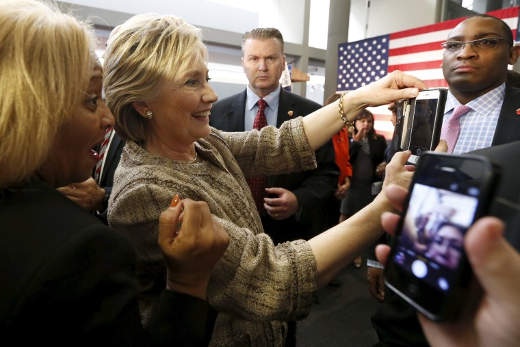 Image: Democratic U.S. presidential candidate Hillary Clinton takes photographs with supporters at Southwest College in Los Angeles