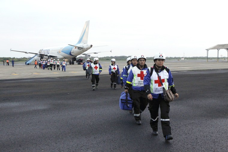 Image: Red Cross members arrive at Eloy Alfaro airport after an earthquake struck off Ecuador's Pacific coast, in Manta