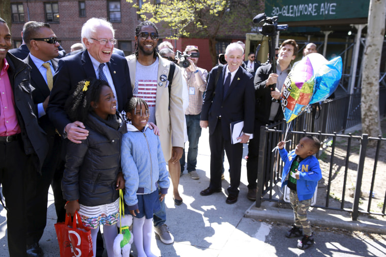 Image: Sanders greets residents during a walk through of the Howard Houses in the Brownsville neighborhood of the Brooklyn borough of New York