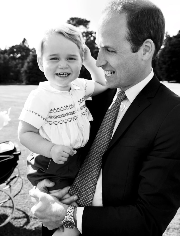 Britain's Prince William holding Prince George