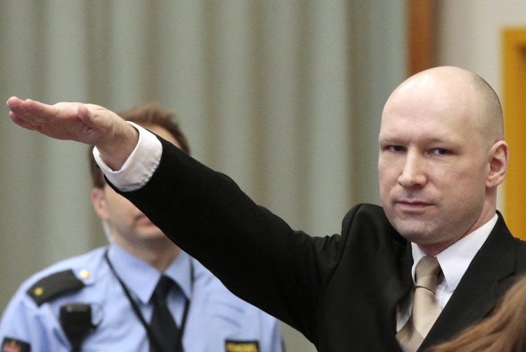 Image: Anders Breivik gestures as he enters a courtroom in Skien, Norway, Tuesday.