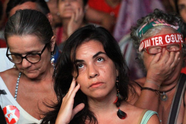 Image: President Rousseff's supporters sulk as they watch a screen showing the voting proceedings