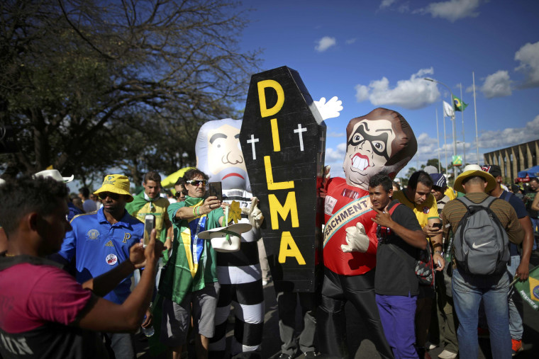 Image: Brazilians with a mock coffin demonstrate in support of the president's impeachment in Brasilia