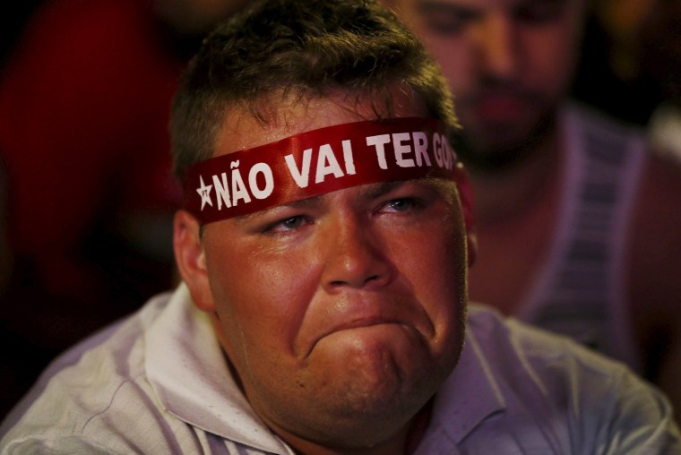 Image:A supporter of President Rousseff broods while watching the televised voting proceeding in Brasilia