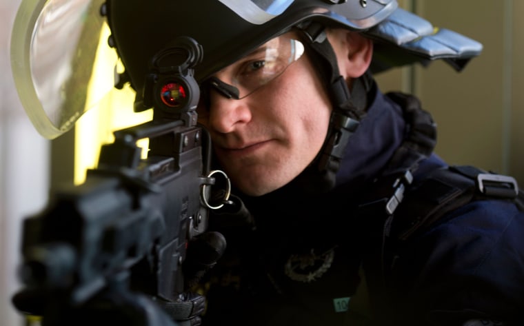 Image: A French police officer shows off a G36 assault rifle on Feb. 29, 2016