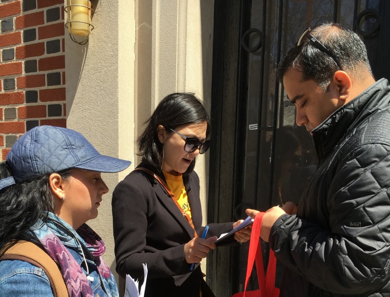 Paola Di Lorenzo (left), Yangchen Chadotsang, and Rasel Rahman try to figure out how to visit registered voters in an apartment building locked from the outside.
