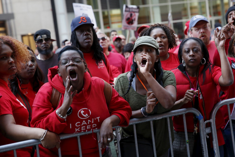 Image: People demonstrate outside a Verizon wireless store during a strike in New York, U.S., April 18, 2016