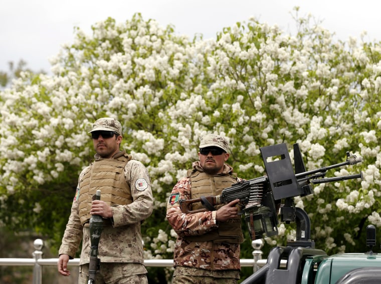 Image: Afghan security forces keep watch after a suicide car bomb attack on a government security building in Kabul, Afghanistan
