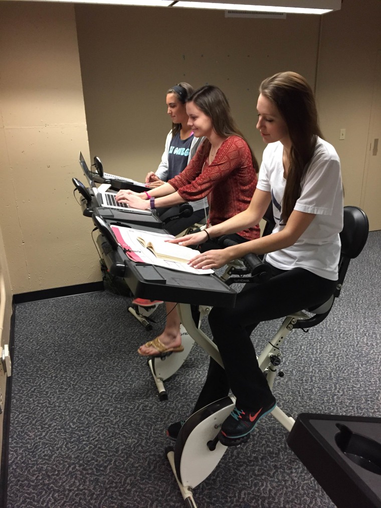 Clemson University interns, from left, Jessie Cashman, Vanessa Mcpherson and Sarah Limyansky try out FitDesks.