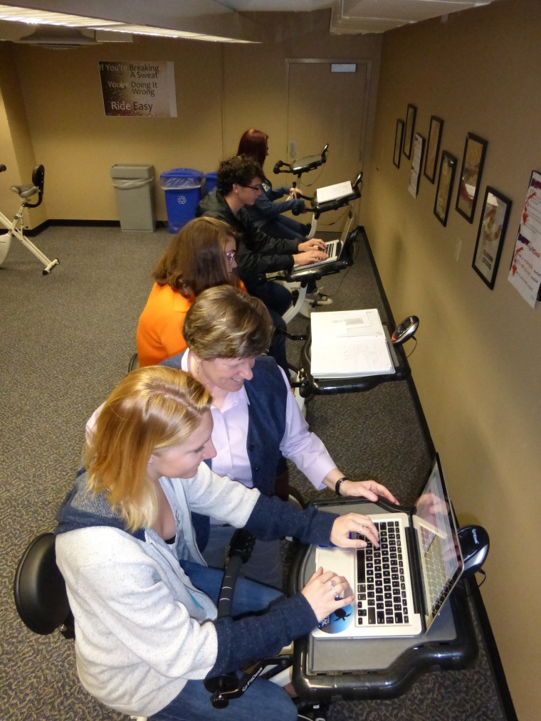 Professor of psychology June Pilcher (working with students in the foreground) is conducting several studies comparing the benefits of FitDesks versus traditional desks.