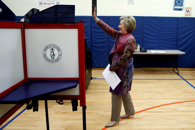 Image: Democratic U.S. presidential candidate Hillary Clinton waves as she carries her ballot to vote in the New York presidential primary election at the Grafflin School in Chappaqua