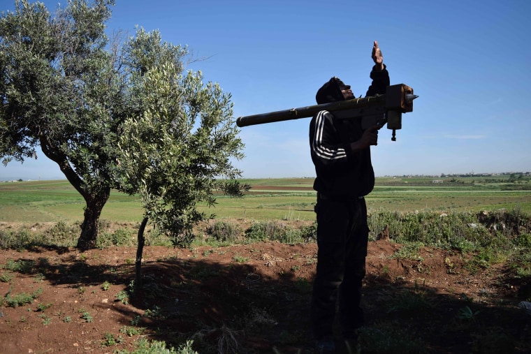 Image: A rebel-fighter monitors the sky holding a FN-6 man-portable air-defence system