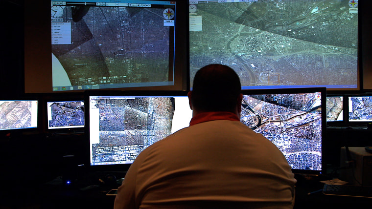 An analyst inspects video feed of a wide-scale aerial surveillance system being utilized by local police departments.