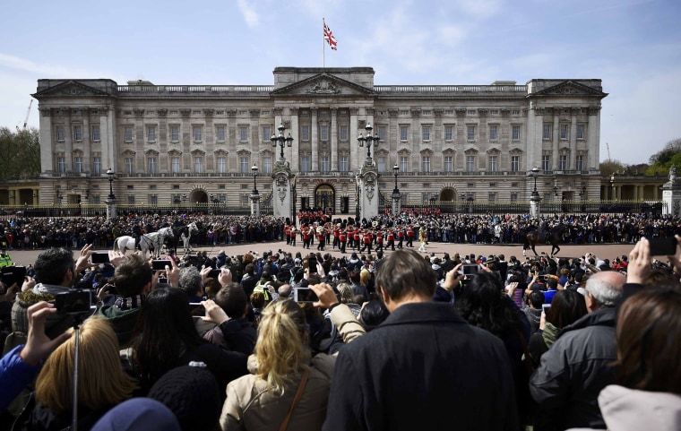 Image: Crowds gather to watch Changing of the Guard outside Buckingham Palace in London