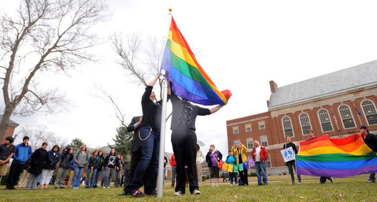 Rebecca Hickman, left, and Evan McDuff raise the Gay Pride flag in the front of the Fogler Library to mark the start of the annual Pride Week at the University of Maine. The events over the coming days are a celebration of the gay, lesbian, bisexual and transgendered people.