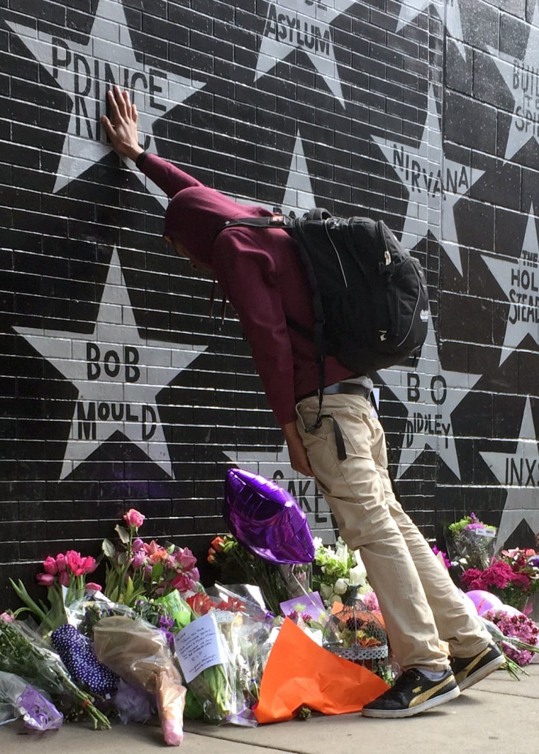 Image: A Prince fan takes a moment at a growing memorial outside First Avenue