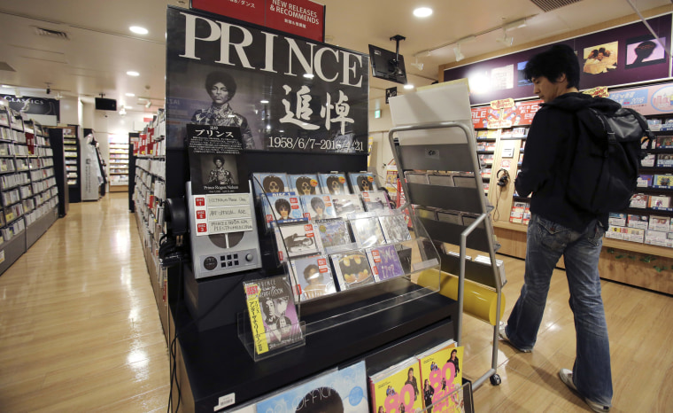 Image: A customer looks around a booth set up in memory of Prince at a music shop in Tokyo