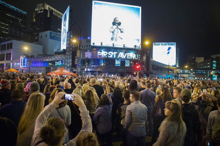 Image: People listen to Prince music during a memorial street party outside First Avenue nightclub