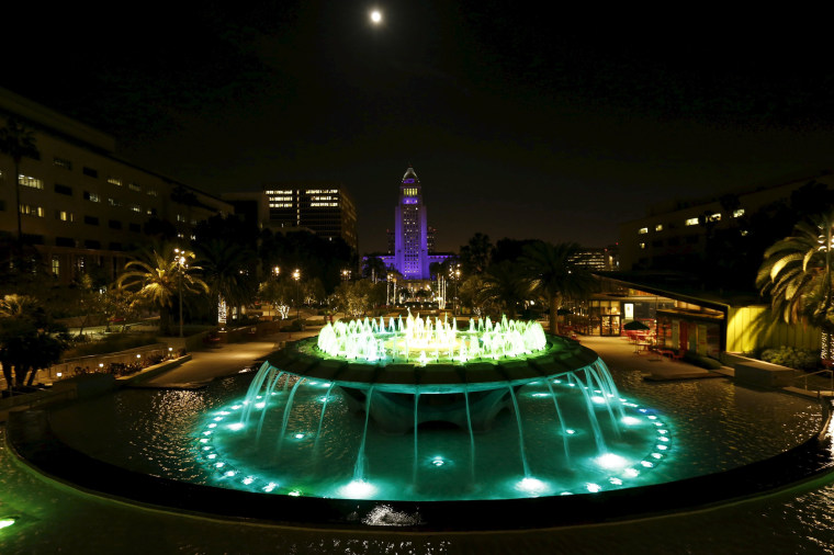 Image: City Hall is illuminated in purple in remembrance of the late singer in downtown Los Angeles, California.