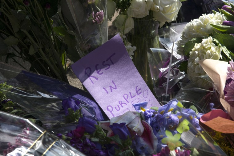 Image: Flowers with notes lay at a memorial at First Avenue nightclub