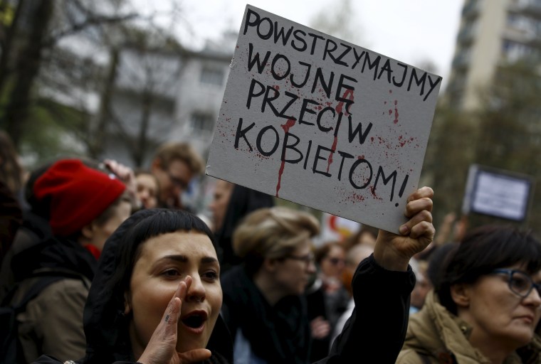 Image: Abortion rights advocate holds a placard at a rally in Warsaw on April 9