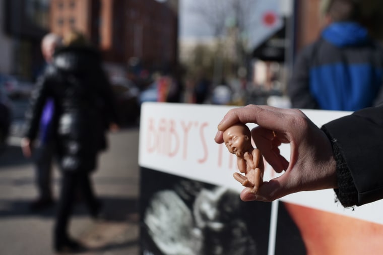 Image: Anti-abortion campaigner outside clinic in Belfast on April 7