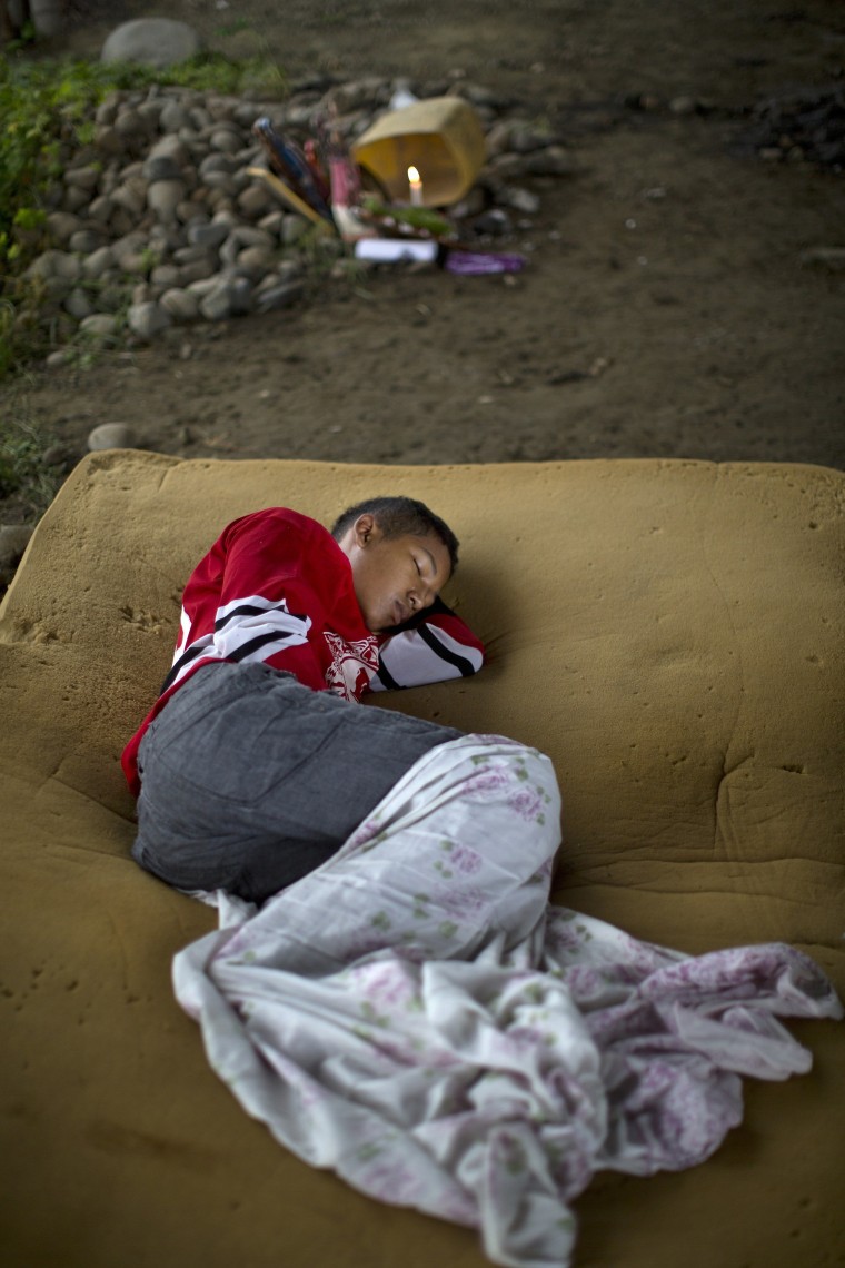 Image: A youth sleeps on a foam mattress after loosing his home in the earthquake in Pedernales, Ecuador