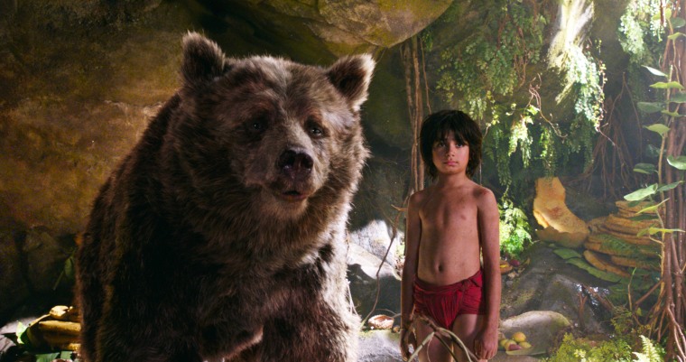 In this image released by Disney, Mowgli, portrayed by Neel Sethi, right, and Baloo the bear, voiced by Bill Murray, appear in a scene from, "The Jungle Book."