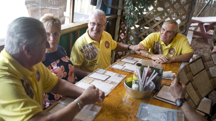 The four friends recount old war stories and catch up on each other's lives after recreating their beach photo from 50 years earlier.