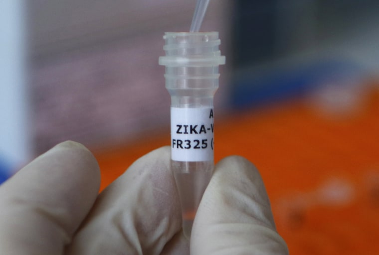 Image: An employee examines tube with the label 'Zika virus' at Genekam Biotechnology AG in Duisburg