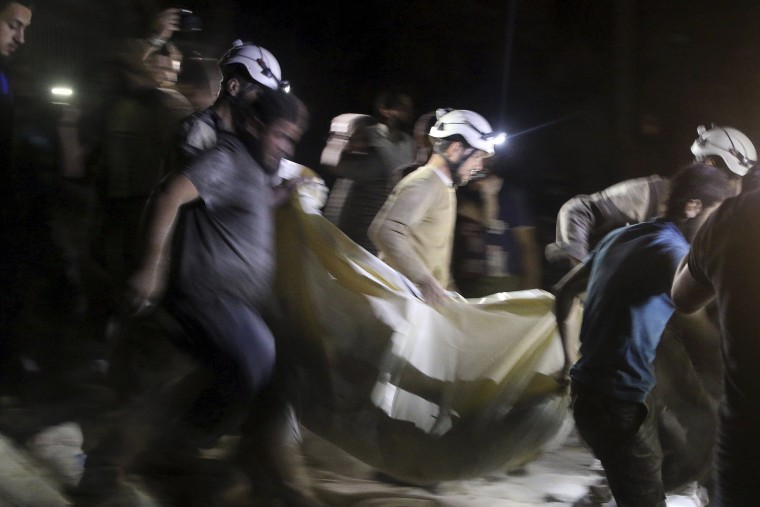 Image: A victim is carried from the hospital in Aleppo, Syria