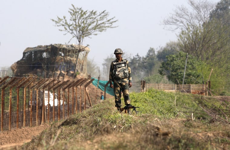 Image: A Border Security Force or BSF soldier stands guard along the India-Pakistan border