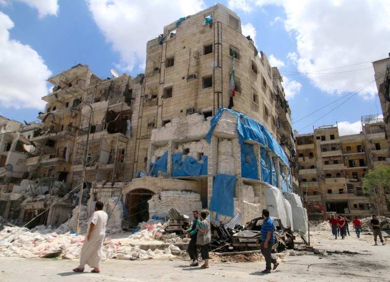 Image: People inspect the damage at al-Quds hospital after it was hit by airstrikes, in a rebel-held area of Syria's Aleppo