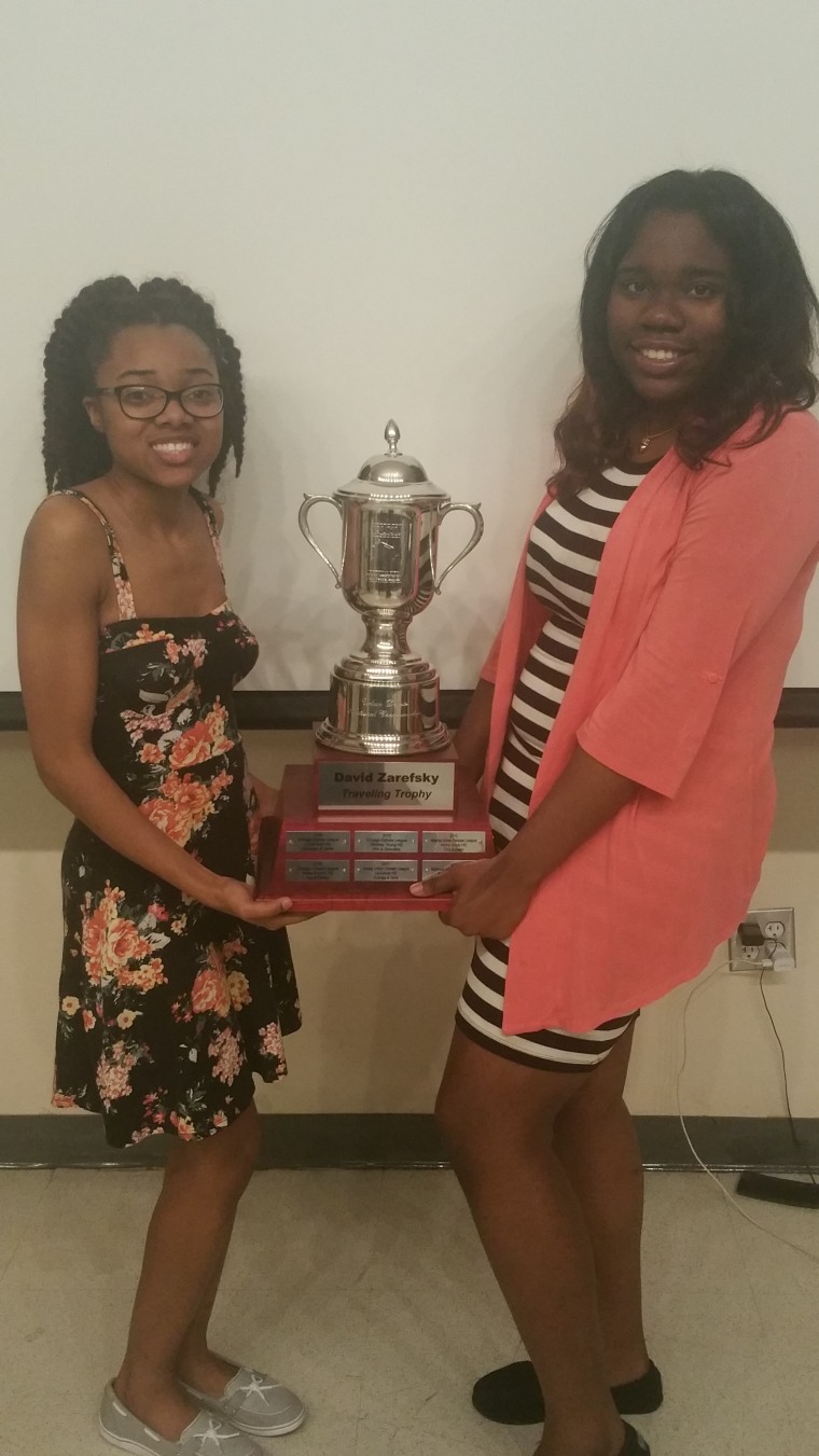 Tamara Morrison (left) and Tiera Colvin (right) hold their trophy after winning the Urban Debate League’s National Championship in San Francisco.