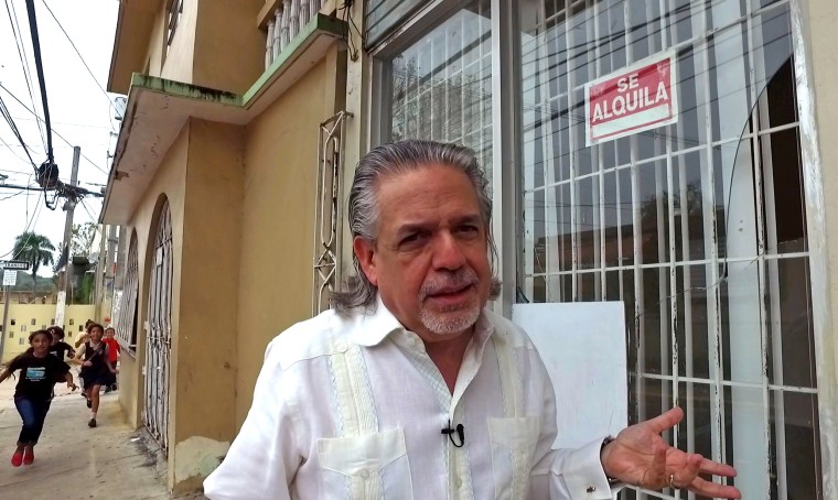 Luis Miranda in front of the travel agency in Vega Alta, Puerto Rico that his mother ran. The town, like the rest of the island, is in a deepening and serious fiscal crisis.