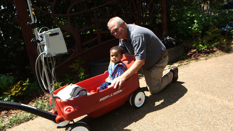 Roger Leggett and Landon in one of Leggett's wagons, designed to help children with medical issues enjoy easier movement. Leggett designed the devices after noticing how difficult it was to move children with IV drips while his granddaughter was in an Atlanta hospital for a brain tumor.