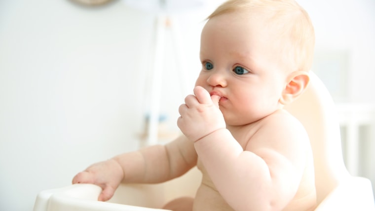 baby eating food with hands