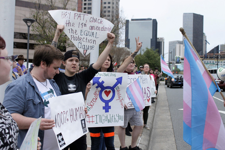 Image: Demonstrators protesting passage of legislation limiting bathroom access for transgender people stand in Charlotte, N.C.