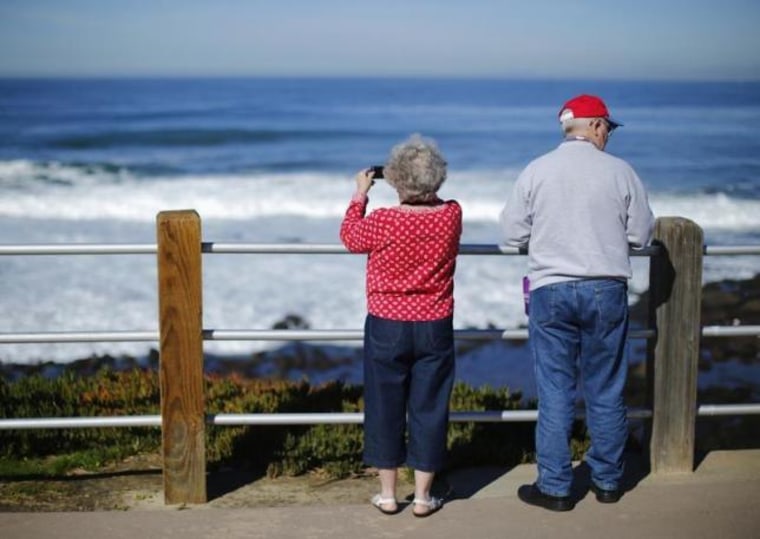 A retired couple take in the ocean during a visit to the beach in La Jolla, California