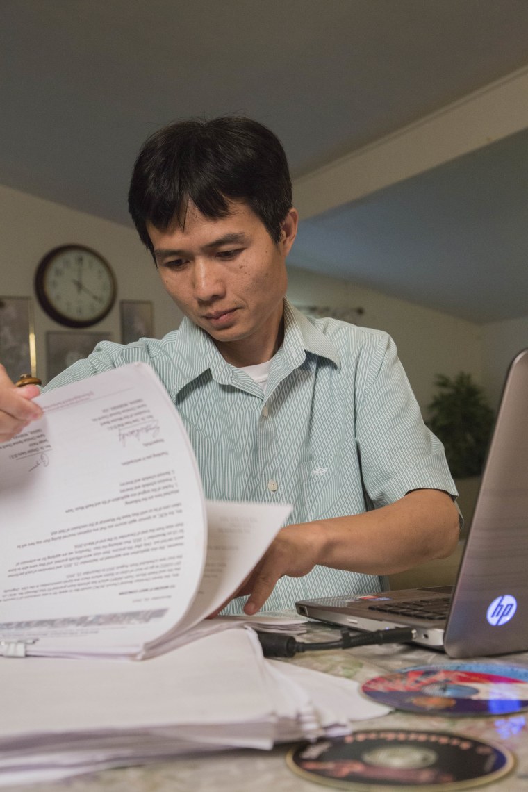 Eh Wah looking over paperwork in Texas, four hours from where he was stopped in Oklahoma.