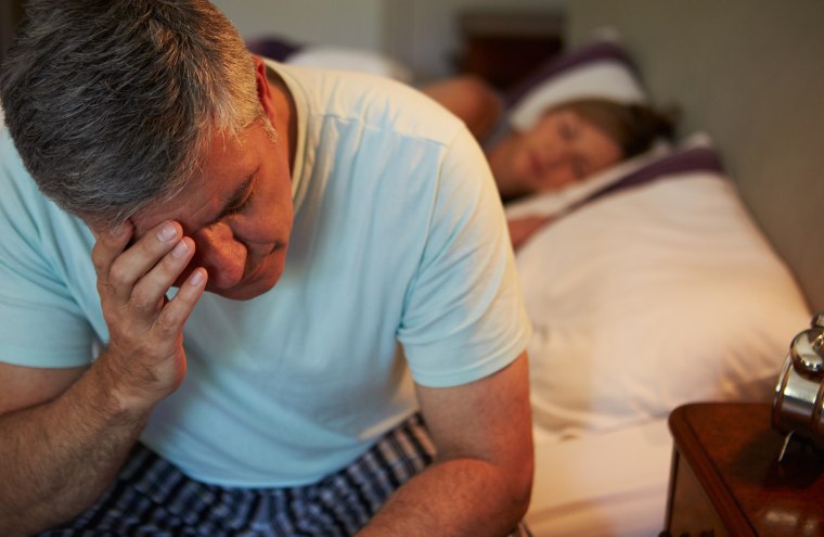 Man Awake In Bed Suffering With Insomnia
