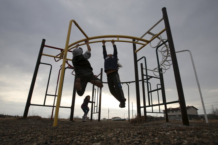 Image: Children play in a playground in the Attawapiskat First Nation