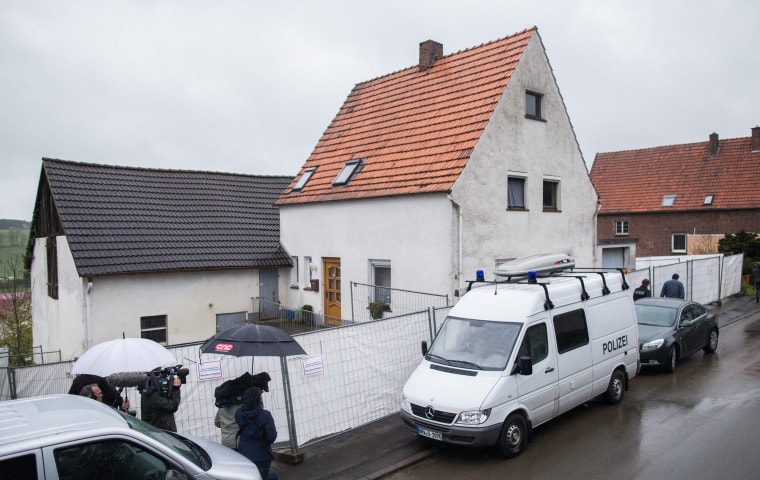 Image: A police vehicle parked in front of the house of a couple suspected of murder in Hoexter, Germany,