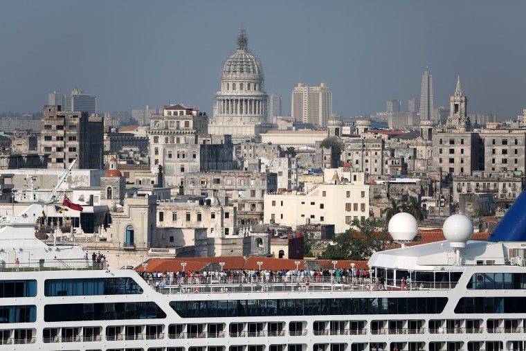 Image: People look at the city of Havana from the deck of U.S. Carnival cruise ship Adonia as it enters at the Havana bay, the first cruise liner to sail between the United States and Cuba since Cuba's 1959 revolution