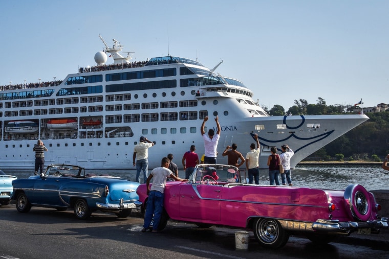 Image: Cubans watch as the first US-to-Cuba cruise ship to arrive in the island nation glides into the port of Havana