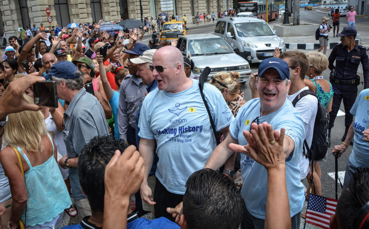 Image: Cruise passengers walk in the streets of Havana right after disembarking