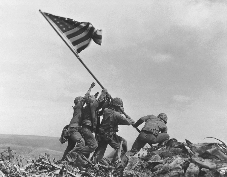 U.S. Marines of the 28th Regiment, 5th Division, raise the American flag atop Mt. Suribachi in the Puliltzer Prize winning photo.