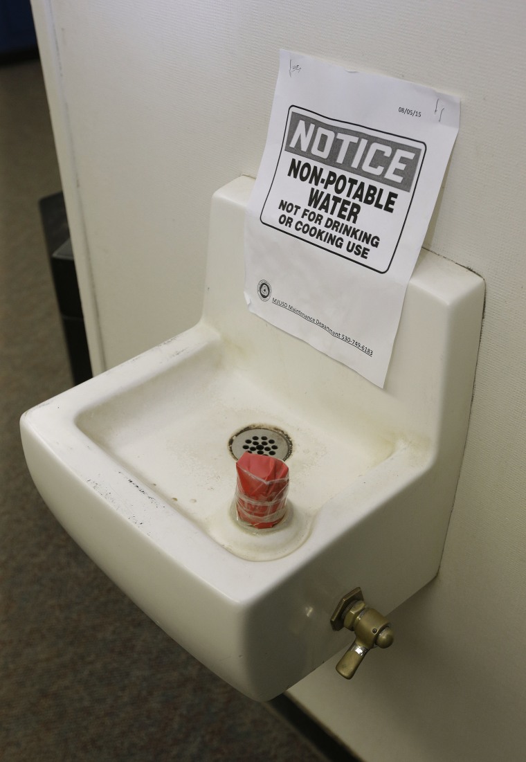 Image: Tape covers the spout and a sign warns students not to use this water fountain